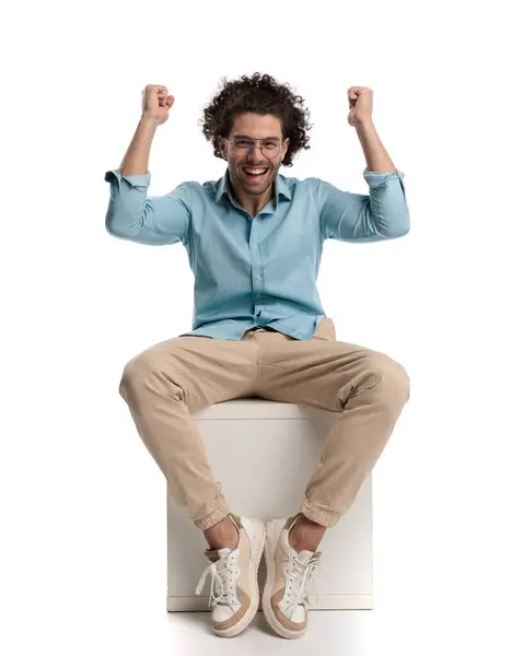 Excited Casual Man Celebrating Fists Air While Sitting Box Isolated — Stock Photo, Image