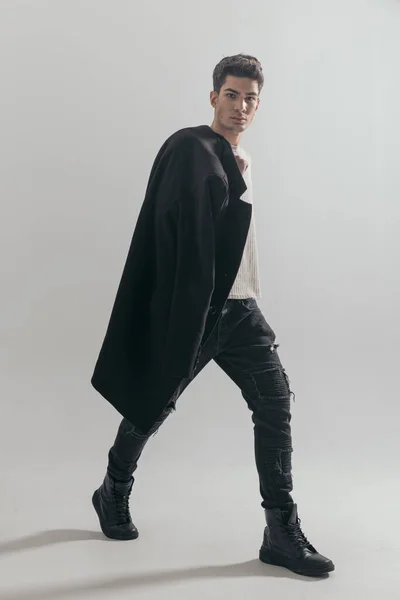 Handsome Guy Walking Side Grey Background While Holding Black Coat — Stock Photo, Image