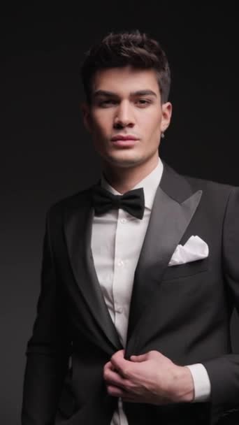 Elegant Man Buttoning His Black Tuxedo While Standing Hands Pockets — Stock Video