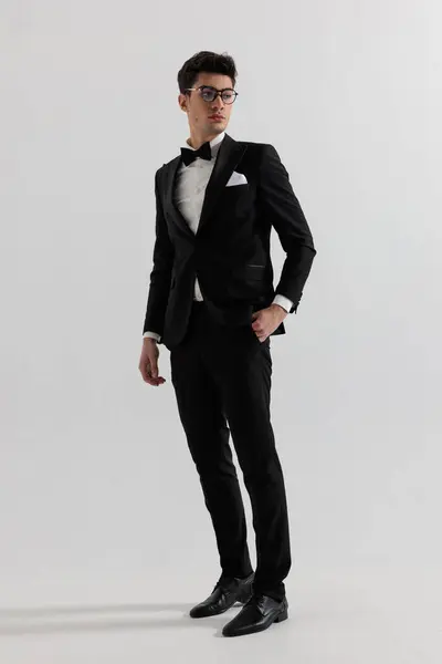 Relaxed Groom Wearing Black Suit Glasses Looking Side While Standing Stock Picture