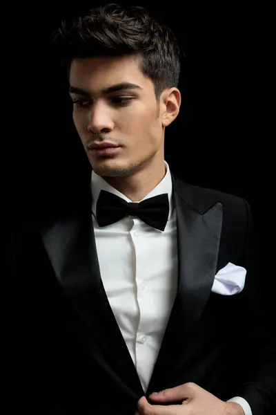 Portrait Sexy Young Man Buttoning Black Tux Looking Side While Royalty Free Stock Images