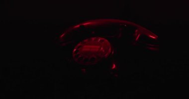 Geçmiş zaman kavramı, nostaljik dokunuşlu eşsiz bir tasarımı olan döner telefon tarafından resmedilmiş karanlık arka planda polis ışıkları.