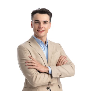 portrait of handsome businessman in beige suit and blue shirt holding hands folded while standing on white background clipart