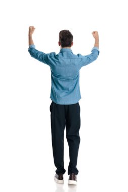 Yumruklarını havada tutan, zaferi kutlayan ve beyaz arka planda kazanan sıradan bir gencin arka plan görüntüsü.