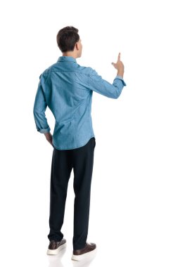 Mavi kot gömlekli meraklı genç adam el ele tutuşmuş ve beyaz arka planda dururken parmağını kaldırmış.