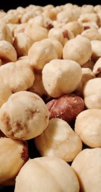 Fındıkların makro görüntüsü yumuşak, kremsi yüzeylerini ve zengin altın renklerini yakalıyor..