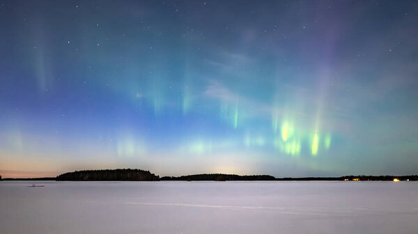 Scenic view of northern lights over frozen lake in Sweden (Aurora borealis) Farnebofjarden national park