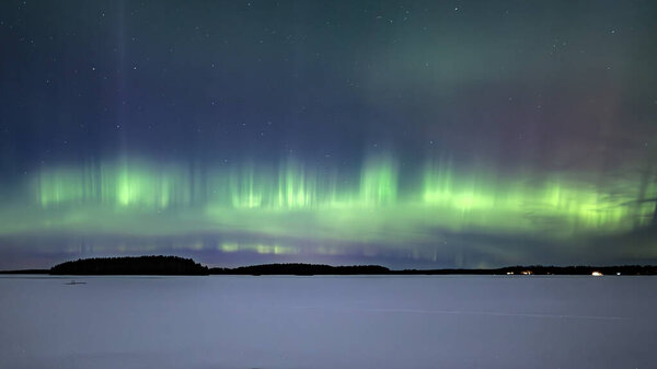 Scenic view of northern lights over frozen lake in Sweden (Aurora borealis) Farnebofjarden national park
