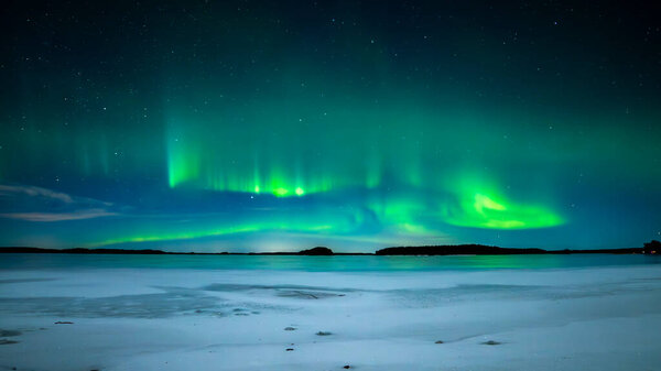 Scenic view of northern lights over frozen lake in Sweden (Aurora borealis) Farnebofjarden national park