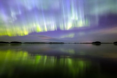 İsveç 'teki sakin göl üzerindeki kuzey ışıklarının manzarası (Aurora borealis) Farnebofjarden Milli Parkı