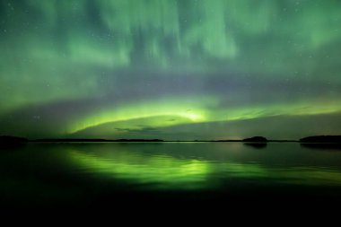 İsveç 'teki sakin göl üzerindeki kuzey ışıklarının manzarası (Aurora borealis) Farnebofjarden Milli Parkı