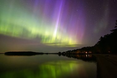 İsveç 'teki sakin göl üzerindeki kuzey ışıklarının manzarası (Aurora borealis) Farnebofjarden Milli Parkı