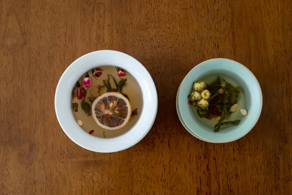 stock image Chrysanthemum and lemon tea are on the table. Vertical shooting