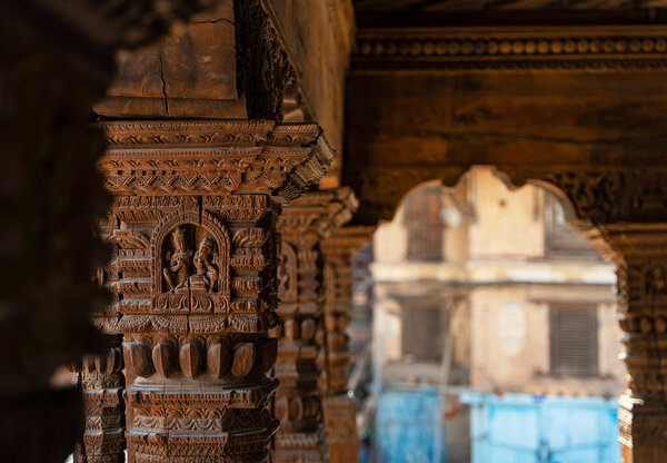 Wooden carved pillars and arch in the temple of Durbar square at Patan Kathmandu, Nepal.