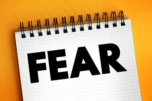 Fear is an intensely unpleasant emotion in response to perceiving or recognizing a danger or threat, text concept on notepad
