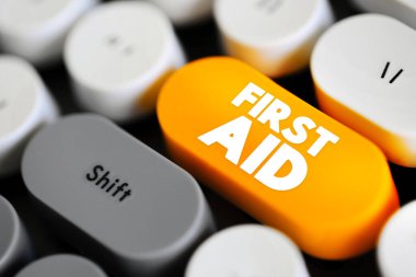 First Aid is the first and immediate assistance given to any person suffering from either a minor or serious illness or injury, text concept button on keyboard