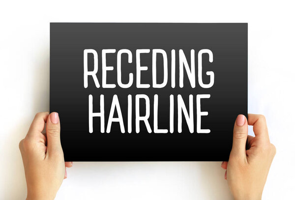 Receding Hairline text on card held by hands. Message symbolizing hair loss, aging, health concerns, treatment, beauty care, and cosmetic awareness
