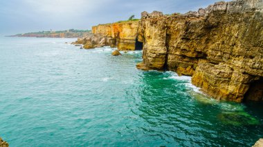 Atlantic coastline near Boca do Inferno - an open cavern near Cascais, Portugal clipart