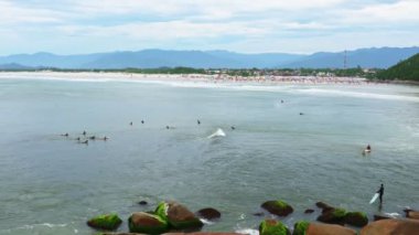 Surfers near Guarda do Embau beach in Santa Catarina province of Brazil