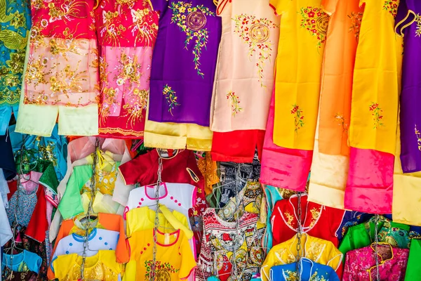 Colorful traditonal Vietnamese clothes in a street shop in Hue, Vietnam