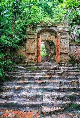 Old stone steps and a gate leading to the Marble Mountain in Vietnam