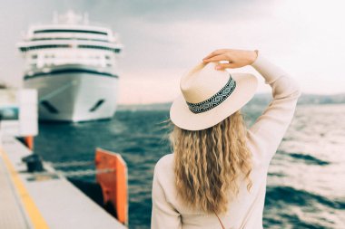 Woman tourist standing in front of big cruise liner, travel female.  clipart