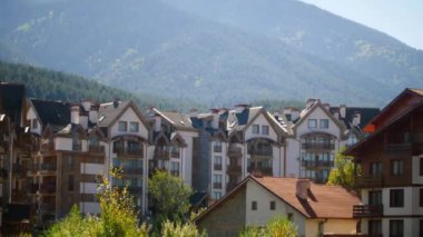 Bansko, Bulgaristan kenti ve Pirin dağları evleri ve renkli sonbahar ağaçları olan panorama. 