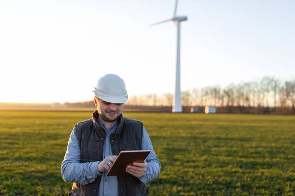 Businessman Checking Wind Turbine Energy Production Stock Image