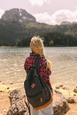 Adventure backpacking woman enjoying view of majestic mountain lake explore travel discover beautiful earth. 