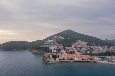 Kırmızı çatıları ve kilise çan kuleleri olan eski ortaçağ taştan evleri. Budva, Karadağ 'ın turizm merkezi ve bir yaz tatili beldesi. Karadağ 'da hava aracı şehir manzarası