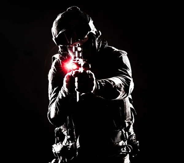 A contour silhouette of a soldier fighting in the darkness. Respect for the sacrifices made by soldiers in defense of their country motherland, symbol of strength and courage. Gun with laser sights