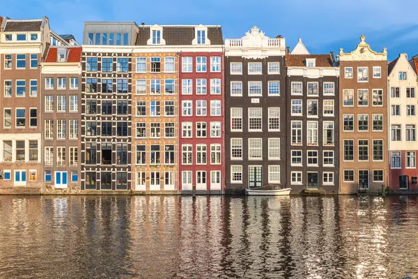 stock image Scenery of Damrak in Amsterdam, Dutch. The houses located direct on the water