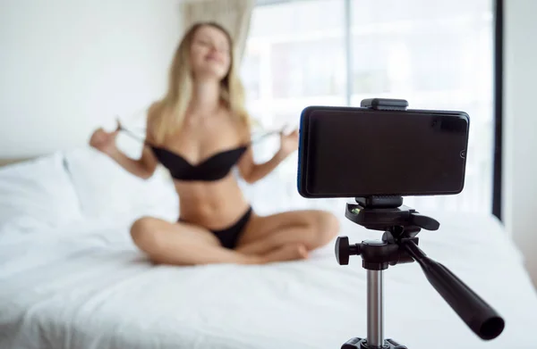 stock image Young sexy woman posing in front of camera and working as webcam model.