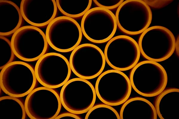 Background Orange Plastic Pipes Stacked — Stock Photo, Image