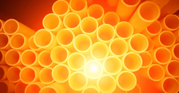 Background Orange Plastic Pipes Stacked — Stock Photo, Image