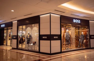 KUALA LUMPUR, MALAYSIA - 04 Aralık 2022: Hugo Boss, alışveriş merkezinin vitrinindeki perakende satış mağazası logosu.