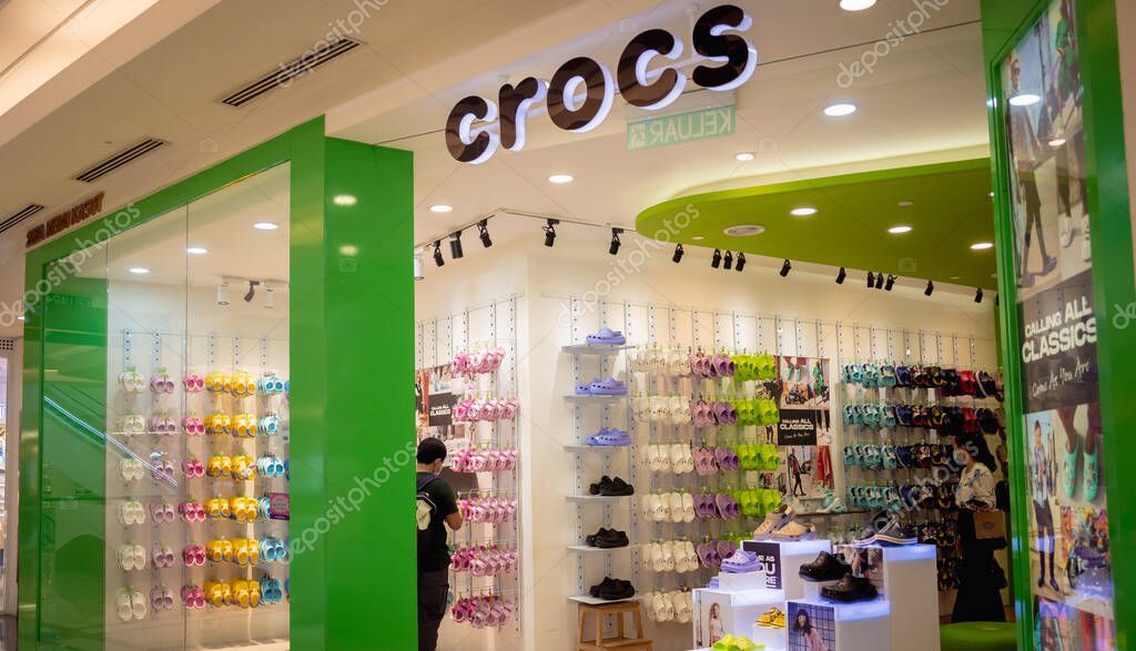 KUALA LUMPUR, MALAYSIA - DECEMBER 04, 2022: Crocs brand retail shop logo signboard on the storefront in the shopping mall.