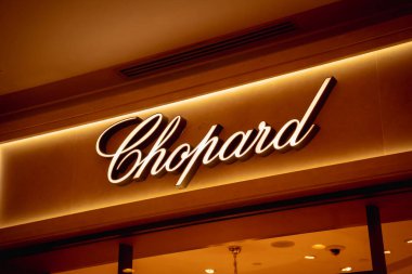 KUALA LUMPUR, MALAYSIA - DECEMBER 04, 2022: Chopard brand retail shop logo signboard on the storefront in the shopping mall.