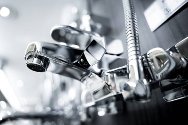Rows of metal water taps at the showroom of a large store.