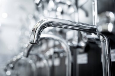 Rows of metal water taps at the showroom of a large store.