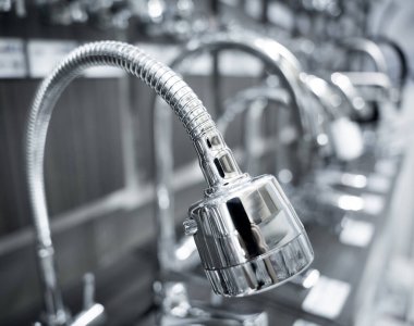 Rows of metal water taps at the showroom of a large store.