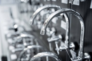 Rows of metal water taps at the showroom of a large store.