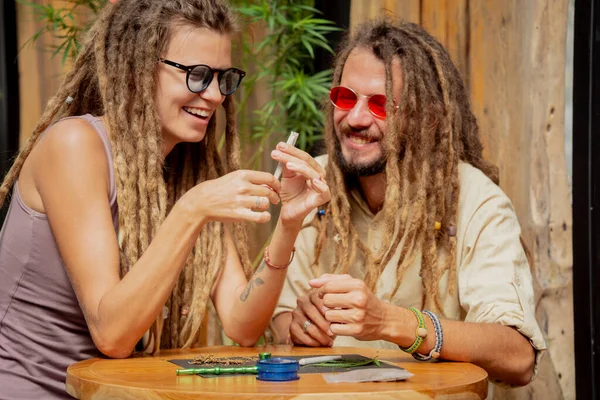 Hippie Style Couple Making Medical Marijuana Cigarettes — 스톡 사진
