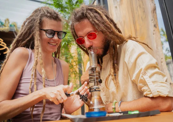 Hippie Style Couple Smoking Medical Marijuana Using Bong — Fotografia de Stock
