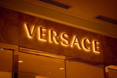 KUALA LUMPUR, MALAYSIA - DECEMBER 04, 2022: Versace brand retail shop logo signboard on the storefront in the shopping mall.