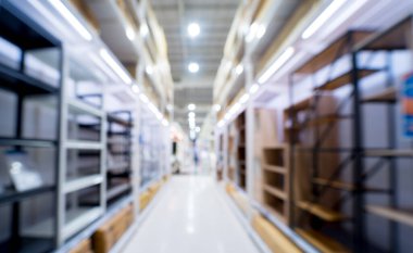 Blurred background of large household appliances and furniture store.