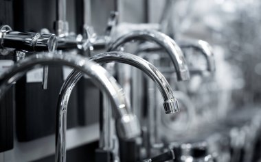 Rows of metal water taps at the showroom of a large store.
