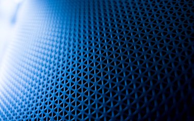 Textures of the speaker with a metal perforated grille.