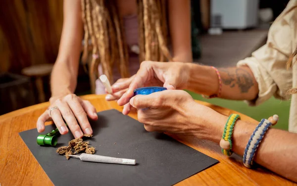Hippie Style Couple Making Medical Marijuana Cigarettes — 스톡 사진
