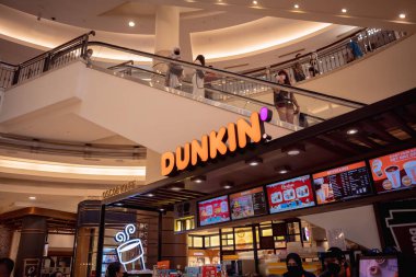 KUALA LUMPUR, MALAYSIA - DECEMBER 04, 2022: Dunkin donut brand retail shop logo signboard on the storefront in the shopping mall.